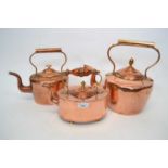 Three late 19th Century copper kettles of graduated size, largest 32cm high