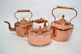 Three late 19th Century copper kettles of graduated size, largest 32cm high