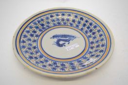 Continental delft dish with polychrome designs of floral decoration with a dog to the centre, 32cm