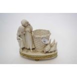 Continental white porcelain model of two children standing beside a basket with chickens, raised