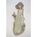 Large Lladro figure of a young girl leaning against a veranda surrounded with flowers on heart