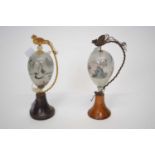 Pair of unusual painted glass egg shaped scenes with Chinese figures, the glass mounted on wooden