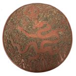 Large Chinese laquer circular box decorated with Chinese symbols and a large sinuous dragon, 25cm