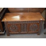 18th Century oak coffer, hinged top over a base with a three panelled front with carved floral