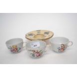 Three 18th Century Italian cups probably cozzi or doccia, all with floral designs together with a