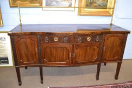 Large Georgian revival mahogany serpentine front side board with brass railed back raised on