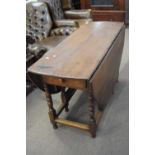 18th century oak drop leaf dining table raised on turned legs with base stretchers fitted with end