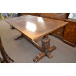 20th Century oak refectory type dining table with heavy turned end supports and a central stretcher,