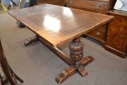 20th Century oak refectory type dining table with heavy turned end supports and a central stretcher,