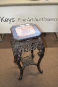 Chinese hardwood plant stand with octagonal top with marble inset over a base with extensive