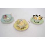 Group of three paragon cups and saucers with floral designs