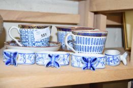 GILT TRIMMED CUPS TOGETHER WITH BLUE AND WHITE BUTTERFLY DECORATED CERAMIC NAPKIN RINGS