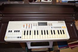 YAMAHA PLASTIC CASE CONTAINING A CASIO PT-30 KEYBOARD CIRCA EARLY 1980'S