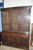 1930S OAK CUPBOARD BOOKCASE WITH LEADED GLAZED SHELVING ABOVE, LENGTH APPROX 168 CM