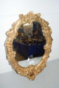 OVAL MIRROR WITH A SHAPED GILT SCROLL BORDER