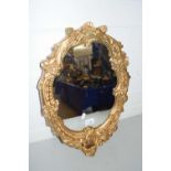 OVAL MIRROR WITH A SHAPED GILT SCROLL BORDER