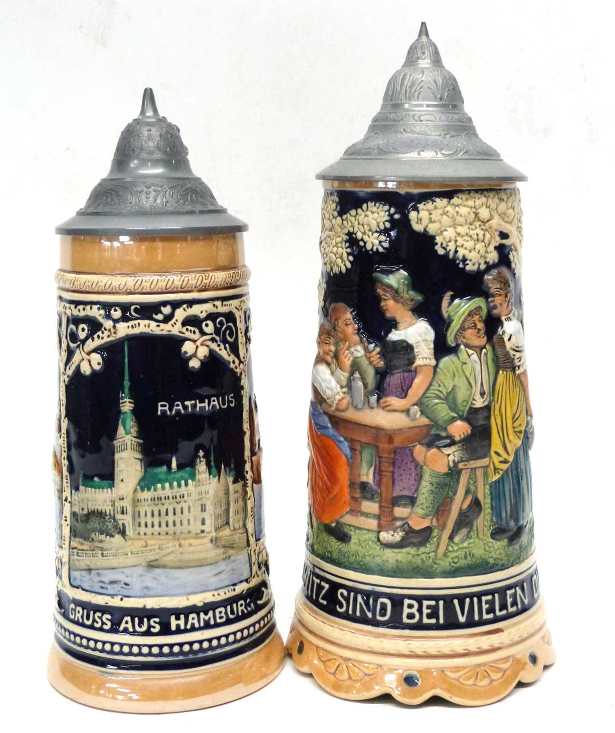 Pair of German Pottery Mettlach style steins, one entitled 'Elbbrucke', the other a musical jug