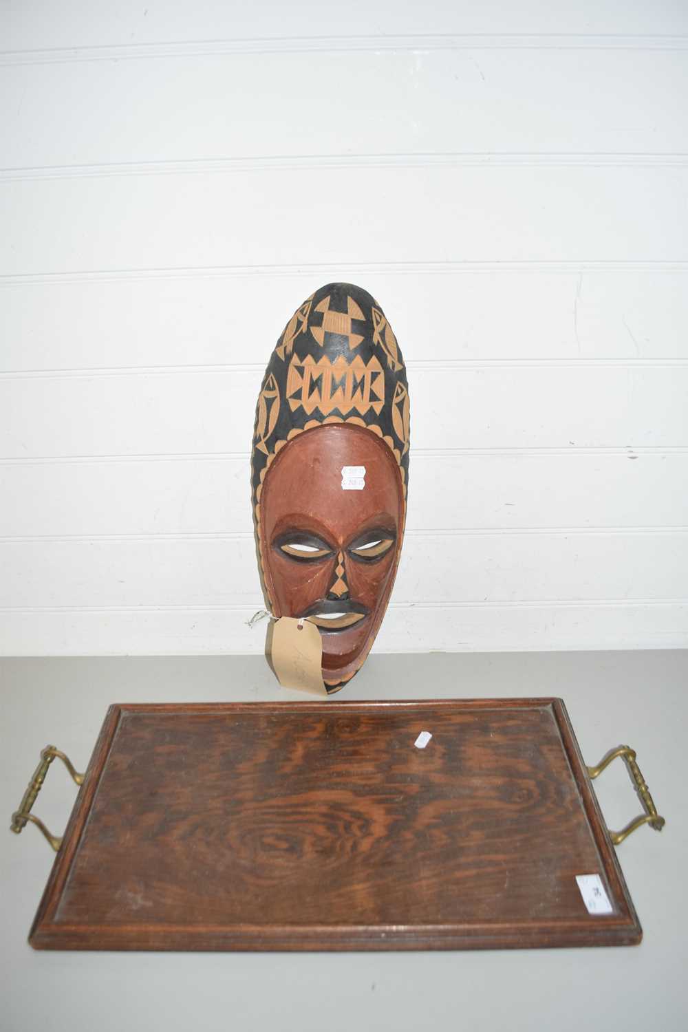 A CARVED WOODEN AFRICAN MASK TOGETHER WITH A WOODEN TRAY