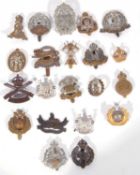 Quantity of 21 20th century British cap badges with Kings cross, varying regiments and dates to