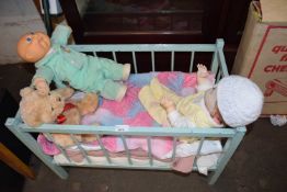 DOLLS COT CONTAINING TWO DOLLS AND A TEDDY BEAR