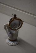 CERAMIC POCKET WATCH HOLDER MODELED AS A HAND CONTAINING A SILVER CASED POCKET WATCH