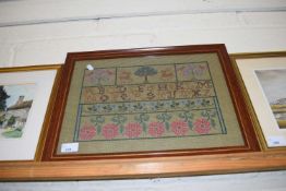 NEEDLEWORK PICTURE WITH ROWS OF ALPHABET AND FLOWERS