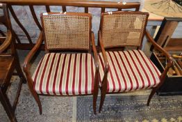 PAIR OF STRIPED UPHOLSTERED CANE BACKED CHAIRS