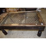 MODERN EASTERN HARDWOOD COFFEE TABLE, GLASS TOP, APPROX 104 X 72