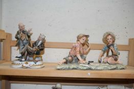 Two Capodimonte porcelain models, a pair of children playing cards and two gentlemen in