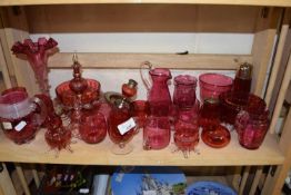 Collection of cranberry glass wares to include various vases, cups, sugar sifter, jugs etc