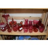 Collection of cranberry glass wares to include various vases, cups, sugar sifter, jugs etc