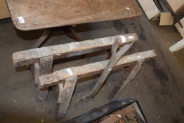 Two trestle or sawing stands and a garden fork