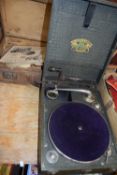 Vintage portable record player and a case of assorted records