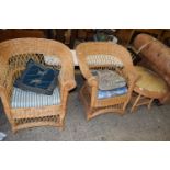 Two wicker conservatory chairs and accompanying table
