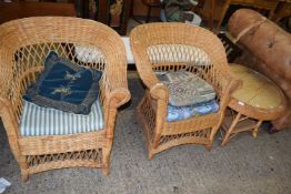 Two wicker conservatory chairs and accompanying table