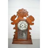 Early 20th Century gingerbread mantel clock in carved wooden case