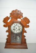Early 20th Century gingerbread mantel clock in carved wooden case