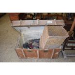 Vintage wooden bound trunk containing assorted items including books, leather boots, corner basket
