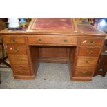 Late Victorian twin pedestal desk with red leather writing surface and adjustable height top