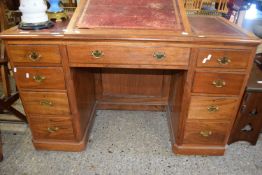 Late Victorian twin pedestal desk with red leather writing surface and adjustable height top