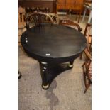 Modern black metal circular topped dining or centre table raised on three circular legs