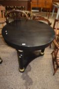 Modern black metal circular topped dining or centre table raised on three circular legs