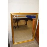 Modern rectangular bevelled wall mirror in gilt finished frame