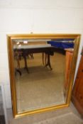 Modern rectangular bevelled wall mirror in gilt finished frame