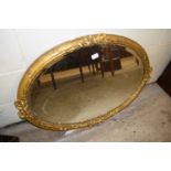 19th Century oval bevelled wall mirror in gilt finish frame with ribbon decoration