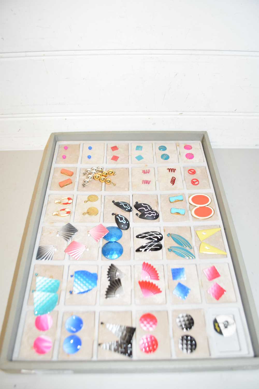 Display tray of various costume jewellery, earrings, several in the Art Deco style