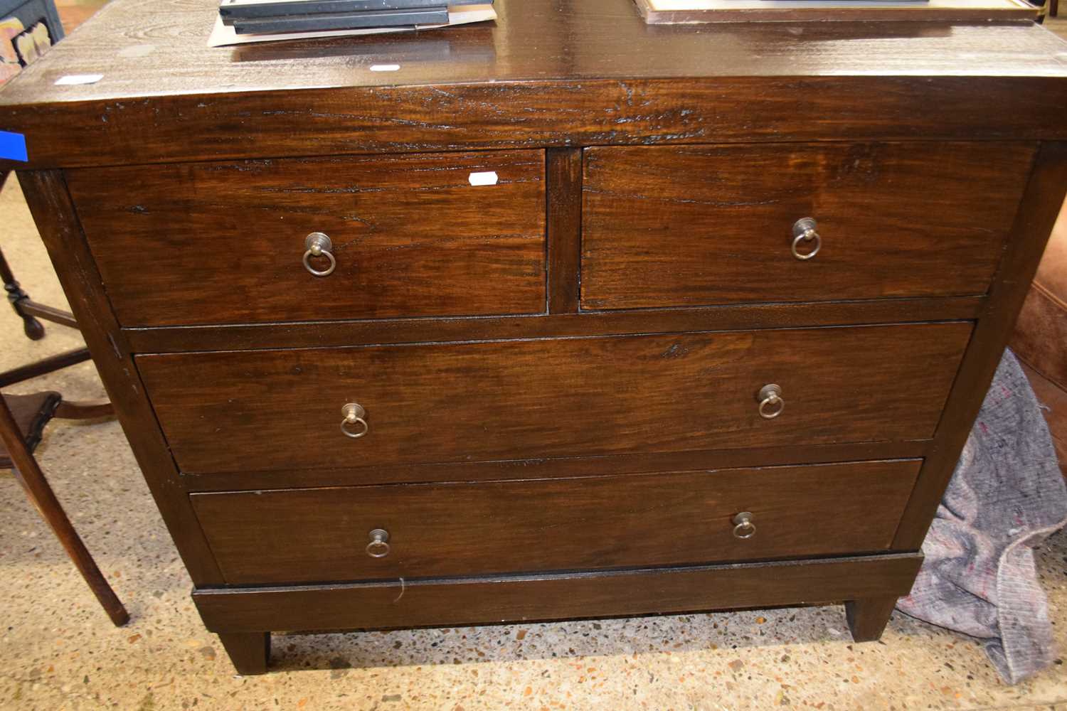 Modern dark wood chest with two short and two long drawers fitted with ringlet handles