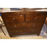 Modern dark wood chest with two short and two long drawers fitted with ringlet handles