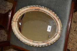 Small oval wall mirror in carved frame
