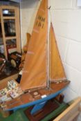 Vintage pond yacht named Karen together with accompanying wooden stand